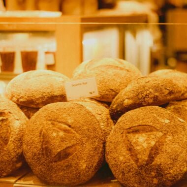 A variety of artisan sourdough breads displayed in a bakery showcase, perfect for culinary inspiration.